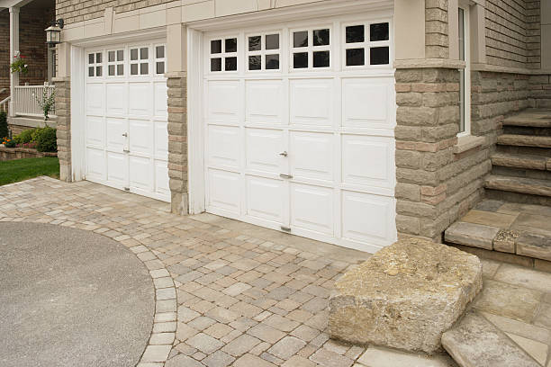 right side of the double garage in the front of the stone house.